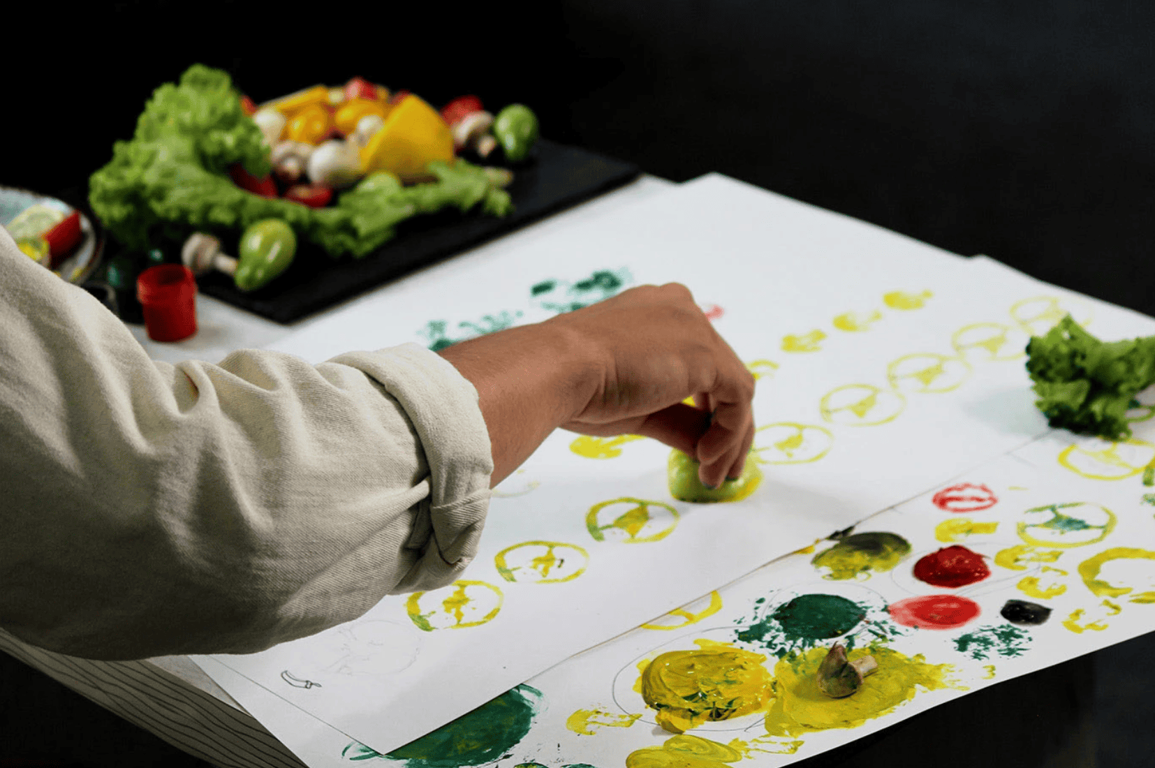 Creative agency designer using fresh vegetables to stamp organic patterns for Innery brand identity,