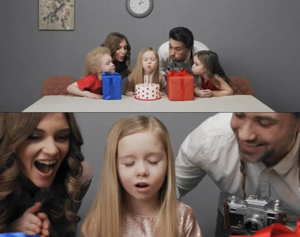 Family celebrating a little girl’s birthday as she makes a wish and blows out candles on a cake, part of Chudo-Park video ad.