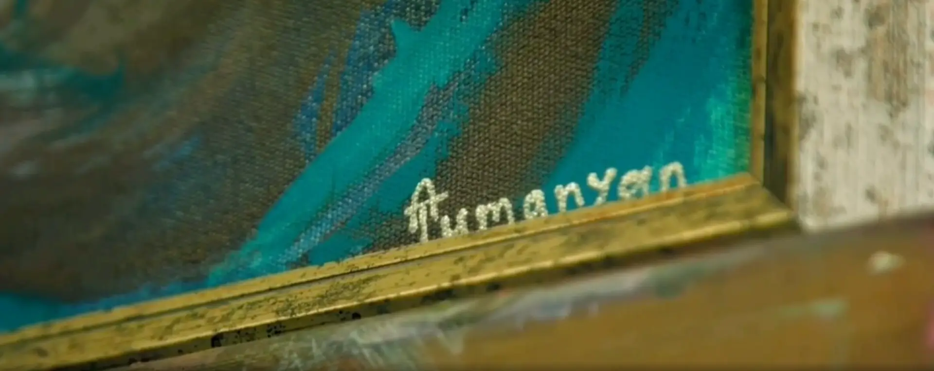 Close-up of Armine Tumanyan’s signature on a painting canvas, featured in SHACLAMIAN’s personal branding film.