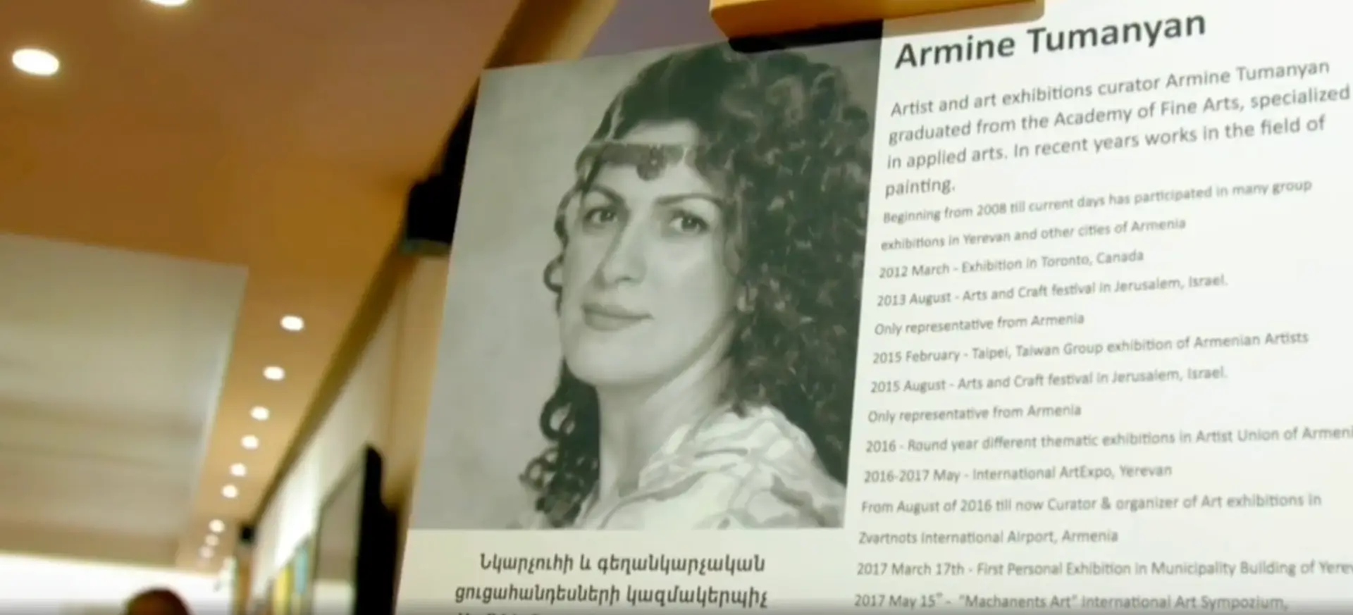Exhibition panel featuring Armine Tumanyan’s portrait and biography, highlighting her career as an artist, curator, and organizer of international art events.