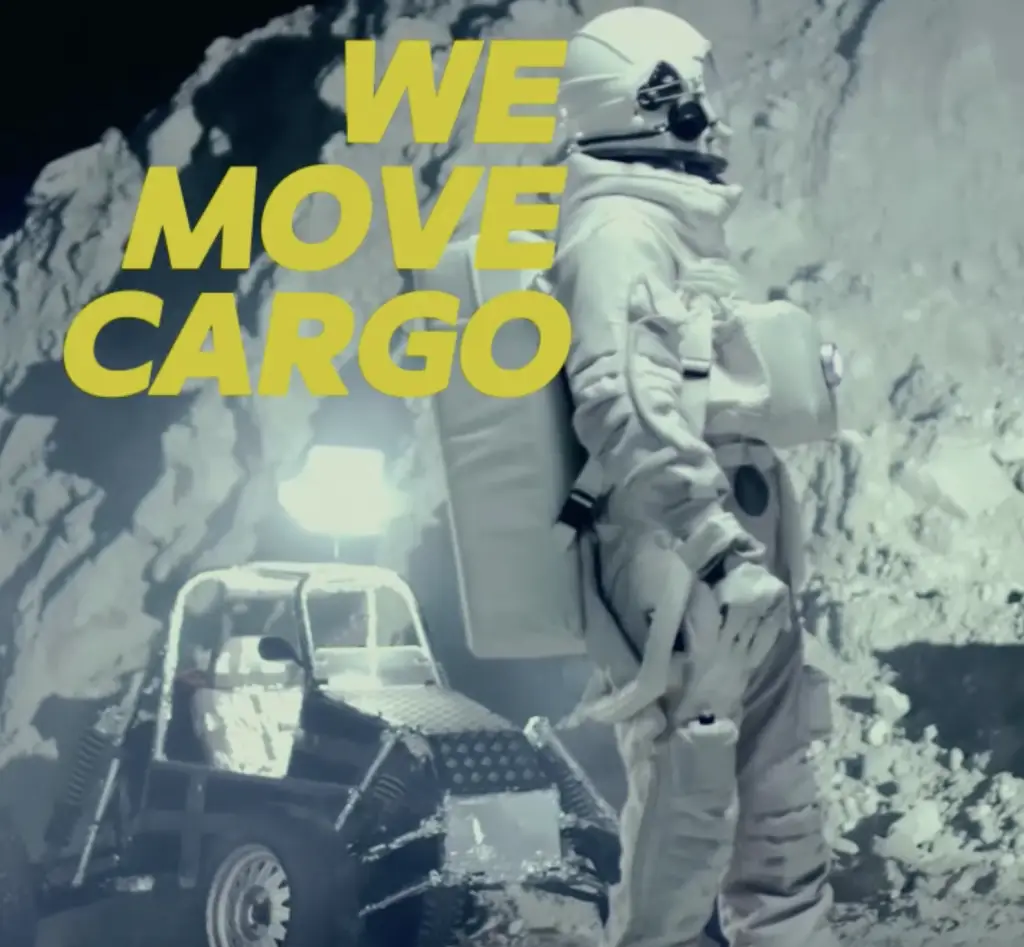 Creative ad visual for Northcape Cargo concept showing astronaut with bold yellow text ‘We Move Cargo’ — emphasizing straightforward logistics branding.